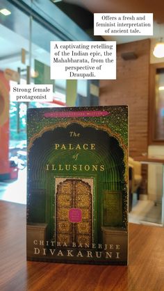 a book sitting on top of a wooden table in front of a glass door with the words palace illusion written above it