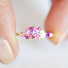 Item Details: 1.50 carats of ombre natural pink sapphires in pear, round, and marquise. Two round brilliant cut diamonds 0.10 ct (G/VS) One half-moon shaped diamond 0.15 ct (G/VS) The band is 1.8mm wide, half-round Crafted in 14K Yellow Gold This ring was custom-created. Email custom@berlingerrings.com to create a similar ring. Enquire about this ring Design a custom piece with us Pink Sapphire Multi-stone Ring With Diamond, Pink Multi-stone Sapphire Diamond Ring, Pink Multi-stone Sapphire Ring With Diamond, Pink Multi-stone Sapphire Promise Ring, Pink Pear-shaped Rose Cut Diamond Jewelry, Pink Sapphire Three-stone Jewelry, Pink Three-stone Sapphire Jewelry, Marquise Rose Cut Diamond Rings In Pink, Pink Sapphire Three Stone Jewelry