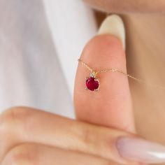 "Our single diamond tiny round ruby necklace is an elegant jewel to wear whenever you want. A meaningful gift that can be given as a birthday gift to those born in July 🤍🤍 Special gifts for your special moments. We produce our jewelery for you in the most perfect way. 🤍🤍 All of our products are carefully crafted from 14K Solid Gold and Real Diamonds. FEATURES * Made to order. * Gold Color Selection: Yellow Gold, Rose Gold, White Gold * Gold KT: 14K * Length: 14\", 16\", 18\", 20\", 22\",24\" Elegant Ruby Birthstone Necklace, Elegant Ruby Birthstone Necklace For Anniversary, Elegant 14k Gold Birthstone Necklace With Prong Setting, Minimalist Diamond Birthstone Necklace With Gemstone, Ruby Birthstone Necklace For Anniversary, Elegant Necklace With Prong Setting And Lab-created Ruby, Elegant Necklace With Lab-created Ruby And Prong Setting, Gold Ruby Necklace, Born In July