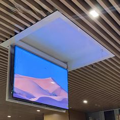 a flat screen tv hanging from the ceiling