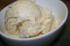 a white bowl filled with ice cream on top of a table