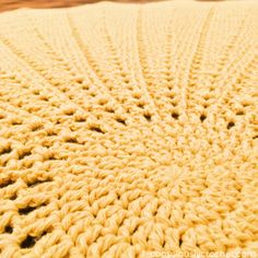 a crocheted blanket is shown on the floor