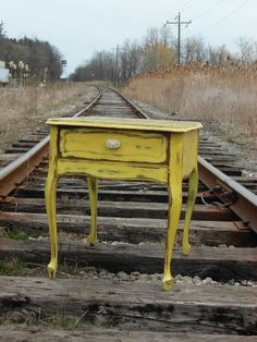 a yellow table sitting on top of train tracks