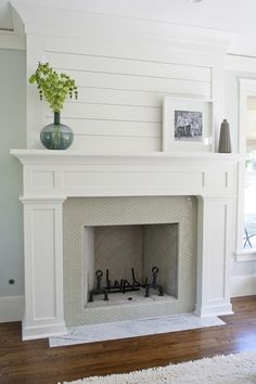 a fireplace with white paint and wooden floors