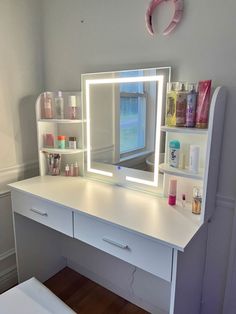 a white desk topped with a mirror and drawers