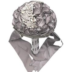 a bridal bouquet with roses and jewels on it's side, tied to a gray satin ribbon