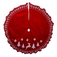 a red christmas tree skirt with white snowflakes on it