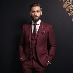 a man wearing a suit and tie standing in front of a wall