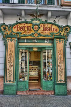 a store front with an ornate green and yellow door