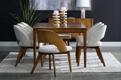 a dining room table with chairs and a rug