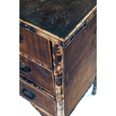 an old wooden cabinet with two drawers on one side and a drawer on the other