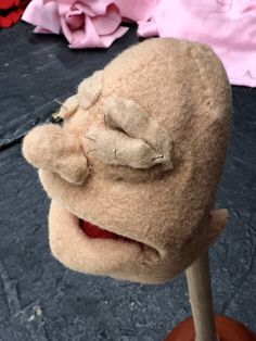 a close up of a stuffed animal on a stick