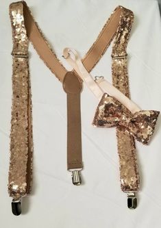 "-Bow Tie & Suspenders SET.Rose Gold Sequins bow tie,Suspenders, Rose Gold glitter,Kid bow tie, Color Sequins Suspenders ,Hand made- Bow Tie pre-tied and made with adjustable white strap and silver Bow tie buckle. Suspenders The front is made of bow tie sequins, the back is made of beige or black 1 \"elastic band. *Size:Adult Bow-2.5\" Width-4.5\" Length. Band 17\"-23\" length Suspenders- 1\" W .Adjustable from 30\" to 50 \" Kids(fit boys 5 years to 10 yrs old) Bow-2 \" Width-4\" Length. Ban Adjustable Gold Bow Tie For Party, Fitted Belts And Suspenders With Bow For Party, Elegant Party Belt With Bow, Elegant Adjustable Gold Belts And Suspenders, Silver Bow Tie, Lace Wedding Garter Set, Wedding Garter Lace, Bowtie And Suspenders, Wedding Garter Set