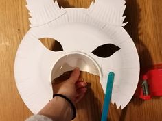 a paper plate with a mask on it