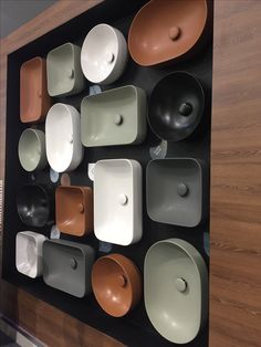 there are many bowls and plates on the wall