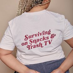 Our Snacks and TV Slogan T-Shirt is a must-have for anyone who loves a bit of Netflix and Snacks!  With a fun, retro slogan, this tee is perfect for lounging or running errands. Comfortable and stylish, it's an essential addition to anyone in the mood for all things cosy. Unisex style T-Shirt comes in Cream with Burgundy print The t-shirt sizes are approx: XS 37"-38" (6/8) S 39"-40" (8/10) M 41"-42" (12/14) L 44"-46" (16) XL 47"-48" (18) XXL 50"-52" (20) Hannah is 5'4" and is wearing the XL. FAI Trash Tv, Mens Nightwear, Slogan T Shirt, Mens Sweatshirts Hoodie, Hoodies Mens, Rock On, Style T Shirt, T Shirt For Women, Shirt For Women