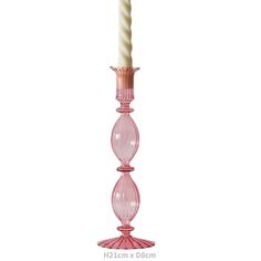 a pink glass candle holder with a white candle