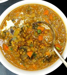 a white bowl filled with beans and carrots