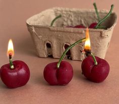 three cherries sitting next to each other in front of a basket