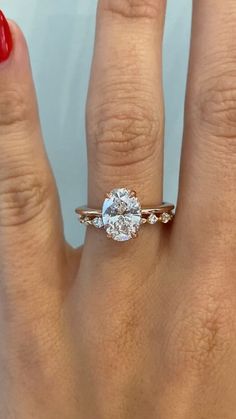 a woman's hand with a ring on it and a diamond in the middle