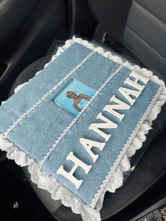 a car seat covered in a blue towel with a picture of a woman on it