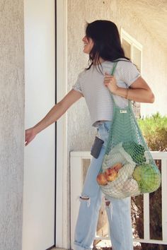 Women carrying sage green mesh bag carrying produce. Mesh Market Bag, Zero Waste Swaps, Kraft Paper Tags, Zero Waste Gifts, Grocery Haul, Market Bags, Bamboo Toothbrush, Mason Jar Lids, Tropical Blue