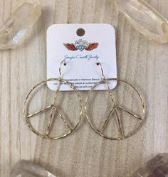 These gorgeous rustic, peace sign earrings are hand fabricated and hand formed, so each pair with vary slightly. They are a part of The Emergi Collection: ‘Emergi’ - to rise up, emerge, free one’s self. Adornment for those extra special moments in life, designed to celebrate life, love, and joy. Made of thick, hammered 16g wire these peace earrings are the perfect accessory for any outfit. Shiny, hammered texture create an organic, rustic feel. These hoops measure 1 inch. 100% handmade in Hermos Symbolic Round Peace Sign Jewelry, Symbolic Peace Sign Jewelry For Gift, Peace Sign Jewelry For Gifts, Hippie Style Gold Nickel-free Jewelry, Hippie Nickel-free Gold Jewelry, Hippie Style Nickel-free Gold Jewelry, Peace Sign Earrings, Peace Earrings, Celebrate Life