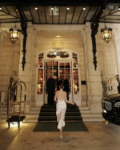 a woman is walking out of a building