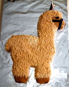 a cake shaped like a llama on tin foil