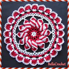 a red and white crocheted doily with an image of a flower in the center