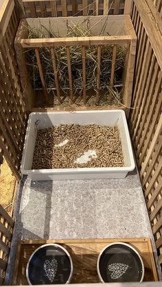 two buckets filled with birds feed on the ground