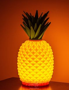 a pineapple shaped lamp sitting on top of a wooden table