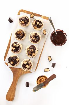 cupcakes with chocolate frosting and peanut butter on a cutting board