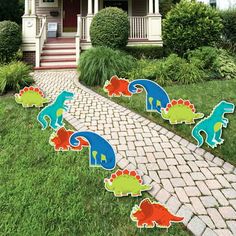 dinosaur party yard decorations in front of a house