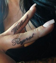 a woman with two fingers that have tattoos on them and the words without prayer written on it