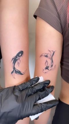 two women with matching tattoos on their arms