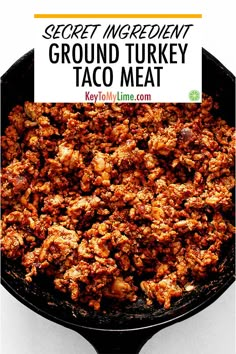 a skillet filled with ground turkey taco meat on top of a white table