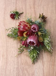 a bunch of flowers sitting on top of a wooden table