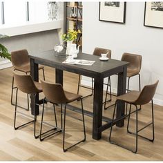 a dining room table with four chairs around it