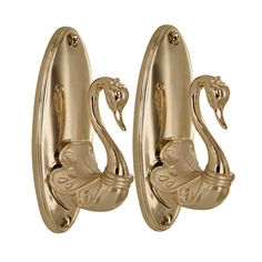 pair of gold swan door handles on white background