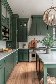 a kitchen with green cabinets and white counter tops, wooden flooring and a chandelier hanging from the ceiling