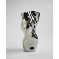 a white and black vase sitting on top of a table