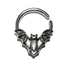 The perfect spooky addition to any halloween costume.  This sweet little bat septum or faith hoop is made from nickel-free solid sterling silver.   The low parts are oxidized with a shiny high polish. Twist open and close to keep the circle shape, the ends are smooth for easy insertion. Can be worn in a variety of piercings.  The inside diameter is measured from the bats head up. Average size is 9mm but can be made in any size you like!  For other sizes enter your request under personalization. I can make the ring in various thicknesses which you can choose at check out. Sizes measure as follows: 14 gauge = 1.63mm 16 gauge = 1.29mm 18 gauge = 1.02mm 20 gauge = .812mm The size in the photos is a 9mm diameter in a 16 gauge.  Comes beautifully packaged and ready for gift giving! Check out my Daith Hoop, Daith Piercing, Gothic Halloween, Nose Ring Stud, Halloween Kostüm, Circle Shape, Body Jewellery, Costume Halloween, Body Jewelry