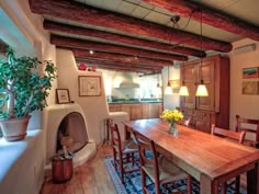 a wooden table sitting in the middle of a living room next to a fire place