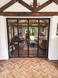 an open living room with wood flooring and glass doors