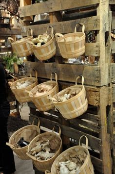 several baskets are hanging on a wooden pallet