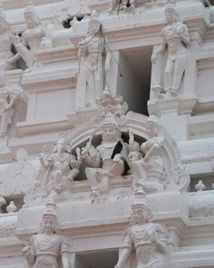 statues on the side of a white building