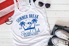 Join the Summer Break Social Club with this Est 2024 Teacher Off Duty Shirt! Featuring a fun and stylish design with palm trees, perfect for educators who are ready to kick back and relax during their well-deserved summer break. Available on a women's racerback tank top or unisex size t shirt in a variety of colors. Key Features: 🌈 Design: Shirt proudly displays the phrase "Summer Break Social Club Est 2024 Teacher Off Duty" with palm trees, capturing the essence of summer relaxation.  Premium Fun Cotton Tops For Leisure, Teacher Off Duty, Gift For Teacher, Summer Break, Gift Teacher, End Of The Year, Social Club, Teacher Shirts, Racerback Tank Top