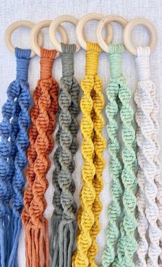 an assortment of different colored ropes with wooden handles