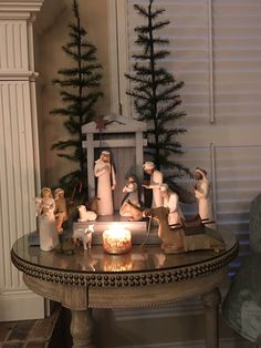 a christmas scene with candles and figurines on a table